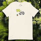 TANKRU TEE by Kaeru Klothing — white unisex cotton t-shirt laid flat, showing full hand-drawn graphic design of a frog holding a strawberry facing a tank with a yellow speech bubble reading “NO STRAWBERRIES FOR FROGS.”
